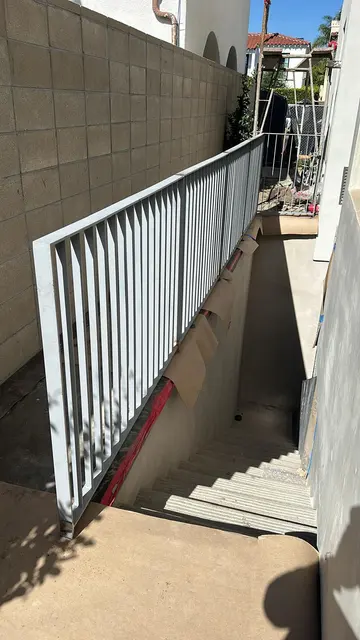 Metal railing beside outdoor stairs