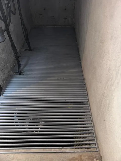 Metal grating in a utility space