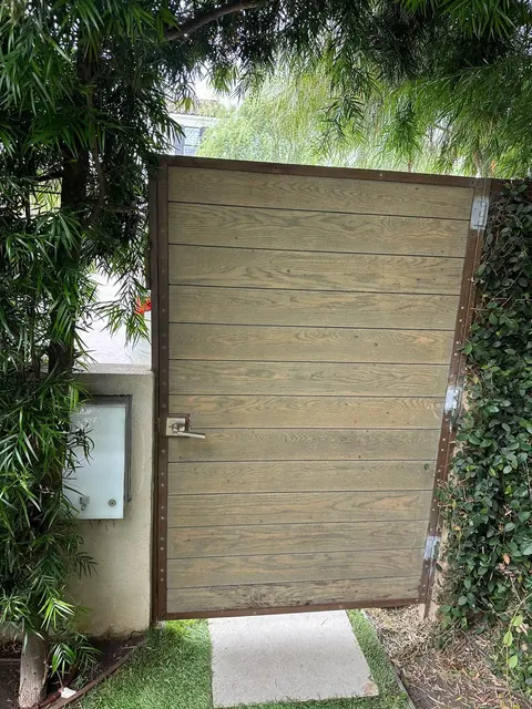 Gate with a metal frame and wood-look panels